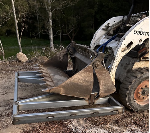 Spreader Bar attached to Bobcat